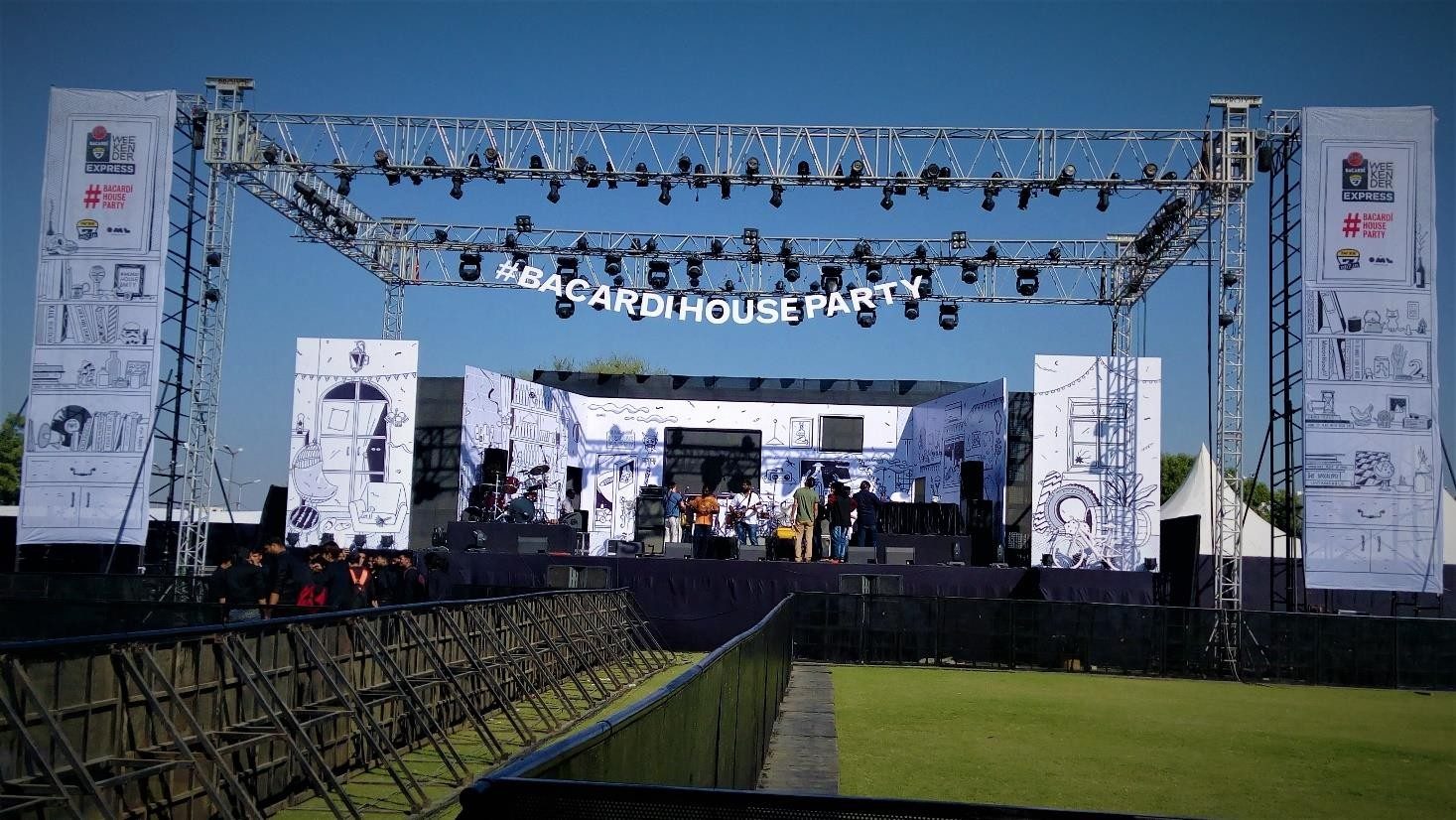 Concert stage washed in blue and white lighting with a large LED backdrop