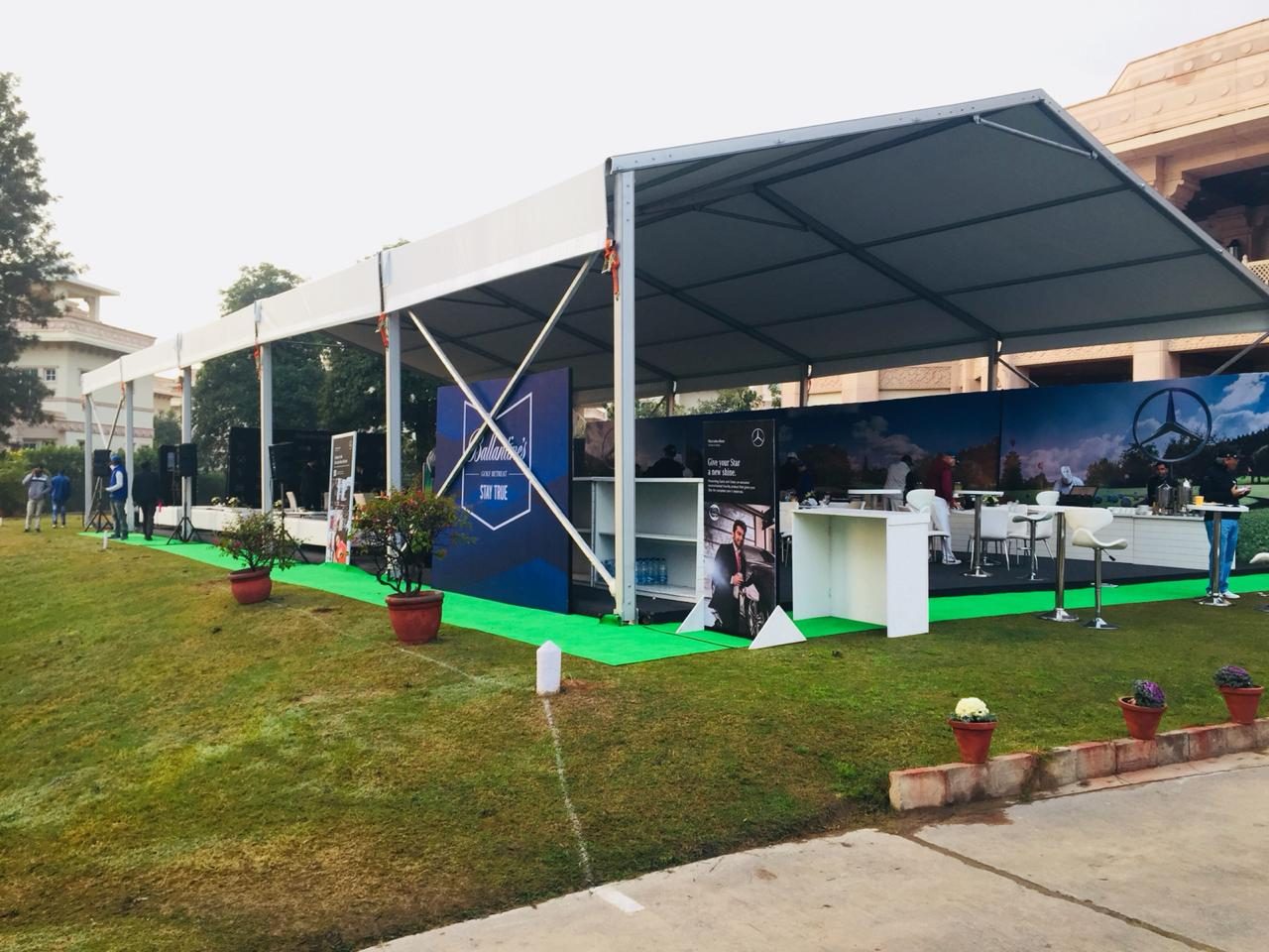 Large clear-span German hanger structure set on a lawn for an event